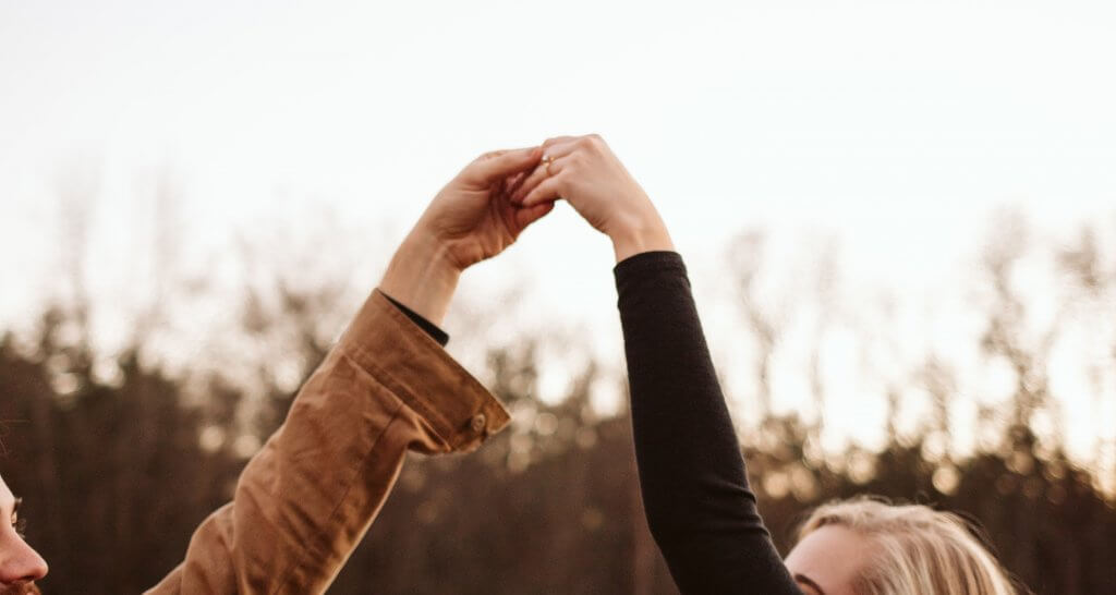 couple holding hand with diamond ring - How to Buy An Engagement Ring A Step-by-Step Guide