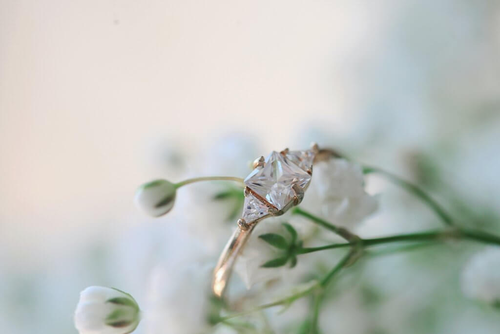 princess cut yellow gold diamond ring with side trapezoids