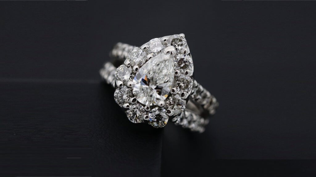 pear shaped diamond split shank round cut halo engagement ring 