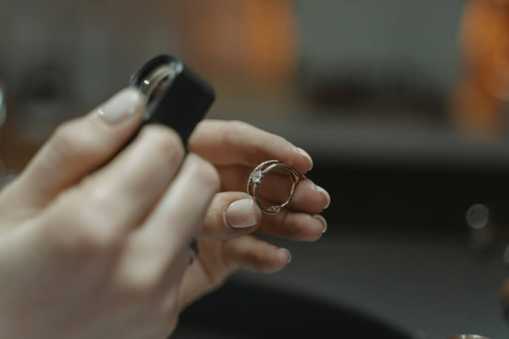 jeweler checking engagement ring for color - Diamond Color